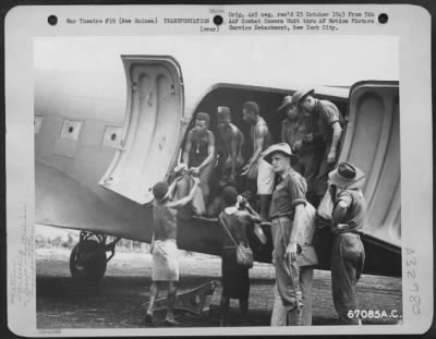 Thumbnail for Consolidated > Natives, supervised by men of the Australian 7th Division, unload supplies from a Douglas C-47 at Nadzab Airstrip in New Guinea. 11 September 1943.