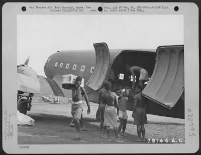 Thumbnail for Consolidated > Natives unload C-47 transport of the 6th Troop Carrier Squadron at Wau, New Guinea where the supplies are ferried from Port Moresby, New Guinea. April 1943.