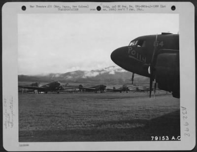 Thumbnail for Consolidated > C-47 transport planes of the 6th Troop Carrier Squadron lined up on Wau, New Guinea, landing strip during unloading operations. Planes are based at Ward's Drome, Port Moresby, New Guinea. April 1943.