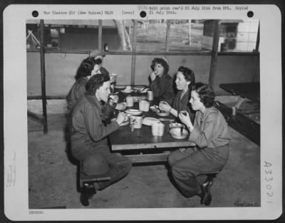 Consolidated > Newly-arrived members of the Women's Army Corps enjoy their first meal at a camp somewhere in New Guinea. They are Pvt. Margaret Zavatsky of Edwardsville, Pennsylvania; Lt. Arline Schonerstedt of Georgetown, Texas; T/4 Gillied Tanksley of Bokoshe