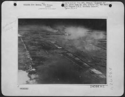 Thumbnail for Consolidated > Japanese aircraft blazing on Mafaing airdrome during Friday's combined strafing attack by American Mitchells and RAAF Beaufighters. These remarkable pictures were taken from a Beaufighter attacking at ground level. The first picture shows a Japanese