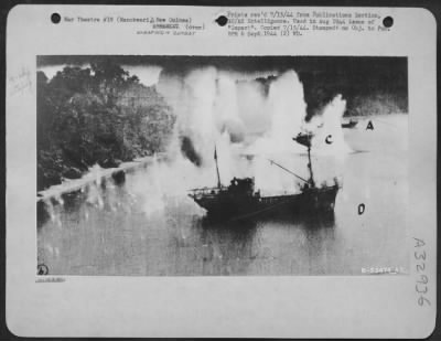 Thumbnail for Consolidated > Freighter "C" is bracketed by explosions, while the water around Freighter "D" is kicked up by strafing from Douglas A-20s at Manokwari, New Guinea. (Taken 9 June 1944)