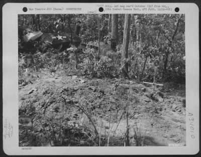 Thumbnail for Consolidated > Graves of glider troops who were killed when their glider crashed into the trees at Chowringhee in Burma. Glider wreckage can be seen in the background. 1st Air Commando Force.