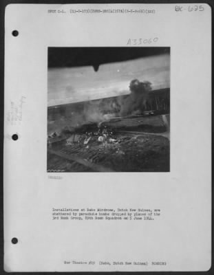 Consolidated > Installations at Babo Airdrome, Dutch New Guinea, are shattered by parachute bombs dropped by planes of the 3rd Bomb Group, 89th Bomb Squadron on 5 June 1944.