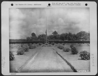 Consolidated > The Flag flies half mast over Panatola American Military Cemetery somewhere in India, 30 May 1945.