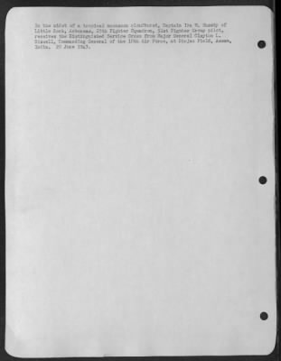Consolidated > In the midst of a tropical moonsoon cloudburst, Captain Ira M. Sussky of Little Rock, Arkansas, 25th Fighter Squadron, 51st Fighter Group pilot, receives the Distinguished Service Cross from Major General Clayton L. Bissell, Commanding General of the