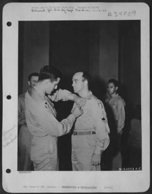 Consolidated > INDIA-Lt. Col. Boebel of the First Air Commando Group pinning the Legion of Merit on Sgt. Glen Abel.