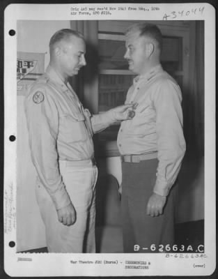 Consolidated > Brig. General Aubry L. Moore presents Air Medal to Col. John A. McCann of 69th Wing, 10th Air Force. Burma, 24 September 1945.