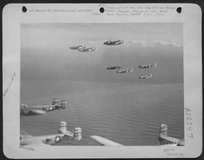 Consolidated > Over quiet Mediterranean waters these 12th AF North American B-25 Mitchell bombers fly toward their buses on Corsica after bombs carried in these same aircraft and wrecked a German-used railroad bridge at Sacile, 40 miles north of Vernice, Italy on