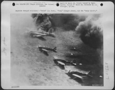 Thumbnail for Consolidated > Japanese damaged airplanes-"Helen" (on fire). "Tony" (single plane), and two "Oscar MK-2's."