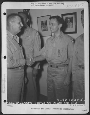 Thumbnail for Consolidated > Lt. General George E. Stratemeyer congratulates Col. Clark after presenting him with the Legion of Merit at an airbase in India on 11 July 1945.