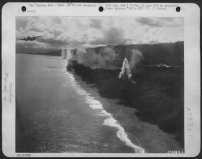 Thumbnail for Consolidated > More than the usual photograph, this picture strikingly conveys the dash, speed and daring that go into an air raid on an enemy base. These low-flying 5th Air Force bombers are B-25's leaving burning Jap planes and installations behind them on Dagua