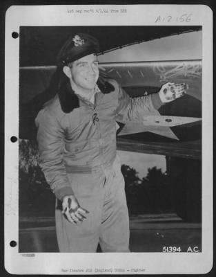 Fighter > Lt. Miles E. Elliott, 604 Franklin St., Shelton, Wash., examines his North American P-51 where pieces of an exploding locomotive which he had shot up ripped it.