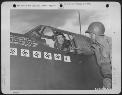 Fighter > ENGLAND-2nd Lt. Thomas Whelan, pilot of a North American P-51 Mustang of the 9th Air force hands a flight ofrm to his crew chief, S/Sgt. William F. Miller, Cissma Park, Illinois, after a flight on D-Day. Lt. Whelan who has over 46 sorties and 100