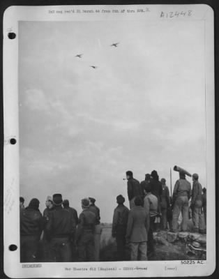 Thumbnail for Ground > Three of the first planes to return from mission are seen encircling field before peeling off for landing. Ground crews below "sweat it out."