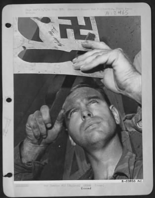 Thumbnail for Ground > ENGLAND-M/Sgt John Coltran has been ground crew chief all the time that bombs were being painted on "Flying Crusader's" fuselage, each bomb meaning a successful bombing raid. Seven Swastikas painted on mean seven German fighters shot down.