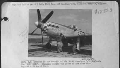 Thumbnail for Consolidated > Capt. K.B. Everson in the cockpit of his North American P-51 Mustang, the "MARY BETH".  Standing beside the plane is his crew chief.  England - 29 April 1945.