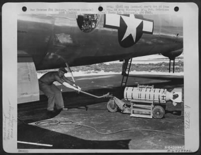 Thumbnail for Consolidated > In Preparation For A Bombing Mission Over Tokyo, Japan, An Armorer Moves Bomb Dolly Holding A 500 Lb. Incendiary Bomb Under The Fuselage Of A Boeing B-29 "Superfortress".  Isely Field, Saipan, Marianas Islands, November 29, 1944.