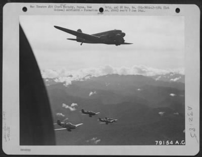 Thumbnail for Consolidated > C-47 Air Transport of 6th Troop Carrier Squadron based at Ward's Drome near Port Moresby, New Guinea wings its way toward Wau, protected by fighter escort below. April 1943.