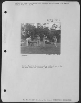 Thumbnail for Consolidated > General Roger M. Ramey decorating enlisted men of the 3rd Bomb Group (L), Dobodura, New Guinea.