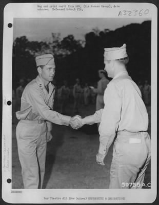 Consolidated > Capt. Carl E. Taylor (left) of Denison, Texas being presented with the Distinguished Flying Cross and the Air Medal by Brig. General Paul B. Wurtsmith at an advanced operational base in New Guinea. Capt. Taylor is a Lockheed P-38 Lightning pursuit