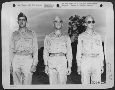 Thumbnail for Consolidated > Multiple awards of medals were made to these three P-38 Lightning pursuit pilots at presentation ceremonies held at an advanced operational base in New Guinea. They are, left to right: Capt. Robert L. Harriger, of Rosebush, Mich., (won the Air Medal