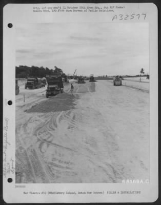 Thumbnail for Consolidated > Immediately after dump trucks emptied their load of coral, graders, scrapers and rollers followed in their tracks, leveling and packing the surface in preparation for laying the steel mat. The strip on Middleburg Island, off the coast of Dutch New