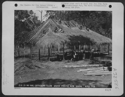 Thumbnail for Consolidated > Natives at work during the construction of the Officers' Club of the 25th Photo Reconnaissance Squadron, 6th Photo Reconnaissance Group, with the 5th Air Force, at a base somewhere in New Guinea. 14 March 1944.