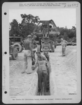 Thumbnail for Consolidated > Men of the 836th Aviation Engineer Group laying conduit wire and cable as well as gas lines and other equipment underground on Middleburg Island, off the coadst of Dutch New Guinea. August 1944.