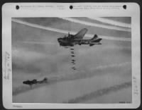 Boeing B-17 Flying Fortresses of the 8th Air Force send their bombs plummeting through clouds on to the important railway marshalling yards at Mainz, Germany. Eerie white vapor trails make a split rainbow over the target as the first of the bombers - Page 15