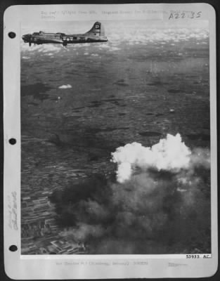 Thumbnail for Consolidated > White boiling smoke surges skyward from a medium tank factory at Nurnberg, Germany, about 90 miles north of Munich, as one of the attacking B-17 Flying Fortresses of the 8th AF passes overhead, 10 Sept 44.