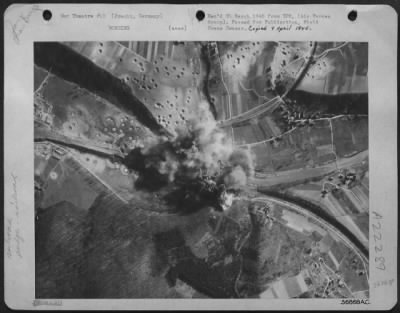 Thumbnail for Consolidated > Blocking rail traffic on the single track line between Koln and Dortmund Martin B-26 Marauders of the 9th Bomb Division hit the six-span, stone arch bridge over the Sieg River at Pracht, near Hamm, March 24, 1945. Bomb bursts blanketing the bridge