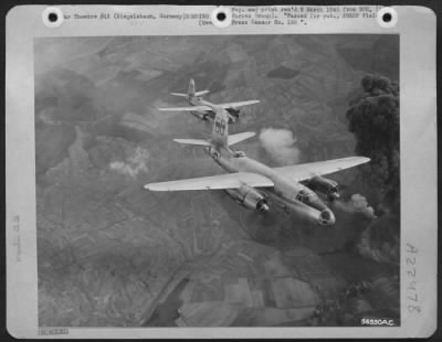 Consolidated > First Tactical Air Force Martin B-26 Marauders pass beside an explosive column of smoke rising almost 10,000 feet above a German ammunition and suspected V-2 storage site which they attacked at Siegelsbach, 18 miles southeast of Heidelberg. Many