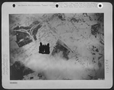 Thumbnail for Consolidated > BOMBS AWAY--Early in the attack on the German oil plant at Sterkrade, Germany, January 22, 1945 by U.S. Eighth Air Force heavies, bombs from the attackers head down in a compact cluster.