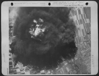 Thumbnail for Consolidated > GAS PLANTS AT ZIETZ BOMBED-Dense smoke with a flaming center seen rising from raging inferno of gas plant at Zietz, Germany, following fierce attack by heavy bombers of U.S. 8th RAF. Direct hits were made on three quarters of the north and containing