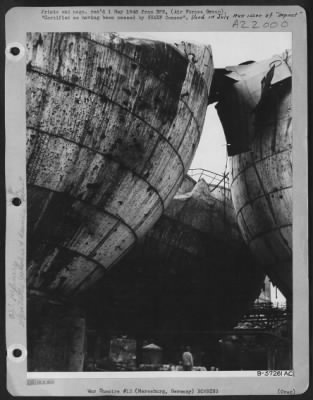 Thumbnail for Consolidated > The Three Huge Tanks, Tilted Askew By The Allied Bombings, Once Held Great Stores Of Ammonia For The Leuna Oil Plant At Mersburg, Germany.  The Tops Of The Storage Tanks Are Wrenched And Dented.