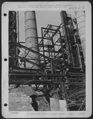 Consolidated > Bomb Shrapnel Fragments Pocked Brick Chimneys, Cut Feed Lines And Knocked Heat Insulation From The Distilling Towers In The Deurag- Neurage Oil Refinery At Misburg, Germany.