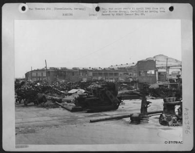 Consolidated > Pieces Of Machinery, Taken Apart In Order To Salvage A Few Usable Parts, And (In The Background) Piles Of Scrapped Machinery Are The Remanants Of This Opel Subsidiary Plant At Russelsheim.  The Destruction Of German Indusrtry By Strategic Bombing Has Been