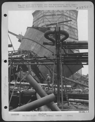 Thumbnail for Consolidated > Blasts And Concussions From Allied Bombs Have Tossed Steel Structures About In The Sterkrade - Holten Oil Refinery.  Temporary Wood Trestles, Evidence Of Attempts At Salvage And Repair Of This Vital Plant For The Luftwaffe, Support The Remaining Pipes. Di