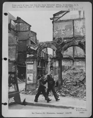 Consolidated > The Usual German Thoroughness Is Nowhere In Evidence In Wiesbaden, Or Anywhere Else In Germany For That Matter, As The Bombed Out Sections Are Left Practically As They Were When They Were Hit.  Two German Civilians Are Shown Here Casually Ignoring The Rui
