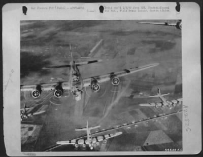 Thumbnail for Consolidated > Boeing B-17 Flying Fortresses of the 15th Air Force form up on their way to continue the air offensive against strategic hun targets deep in enemy territory. This photo was taken from the tail gun position of a preceding fortress. ITALY.