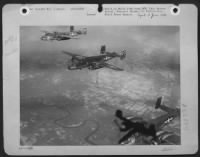 Thumbnail for Its bombardier dead in the wreckage of its flak-riddled nose section, the center plane keeps its place in a 12th AF North American B-25 Mitchell bomber formation on the return flight from a bombing attack against a bridge in northern Italy. - Page 1