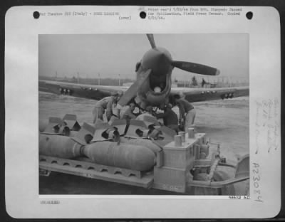 Consolidated > ITALY-Crew loading bombs on a Curtiss P-40 Kitty Bomber to take part in Air Plan called "Operation Strangle."