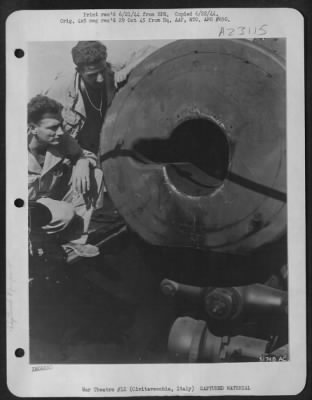 Thumbnail for Consolidated > Two American soldiers inspect the breech of the "Anzio Express," 280 mm railroad gun used by the Germans. The gun was left behind by the fleeing Hun at the coast town of Civitavecchia. The barrel is 72 feet long and fires a 2,000 lb. shell.