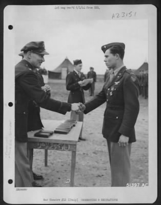 Thumbnail for Consolidated > With the Distinguished Flying Cross pinned to his tunic, 1st Lt. John C. Rogers, Notus, Idaho, and son of O.T. Rogers, 1408 1/2 Leeland Ave., Houston, Texas, is shown here being congratulated by Col. Charles W. Lawrence, Commanding Officer of an AAF