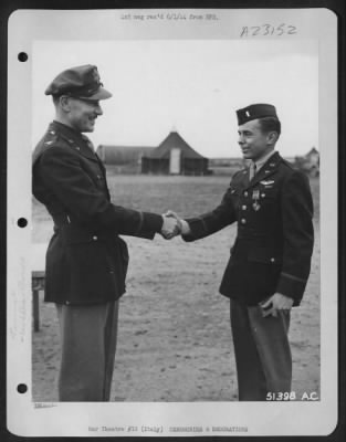 Thumbnail for Consolidated > With the Distinguished Flying Cross pinned to his tunic, 1st Lt. William R. Clark, 5927 Maple Ave., St. Louis, Mo., is shown here being congratulated by Col. Charles W. Lawrence, Commanding Officer of an AAF Wing, who made the presentation to the