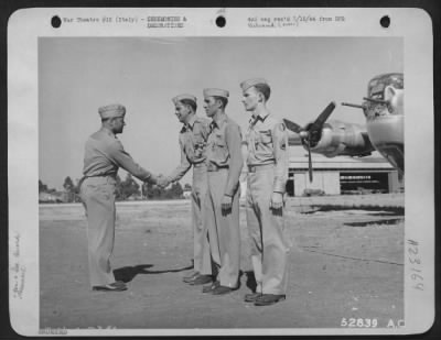 Consolidated > ITALY-Col. H.P. Rush, Wing Commanding Officer, congratulates three men who received the Silver Star for gallantry in action. Left to right are: Lt. James T. Jordan, Philadelphia, Pa.; Lt. Fred G. Wagner, Kalispell, Mont; and S/Sgt. Frank W. Hughes