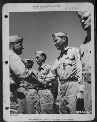 Thumbnail for Consolidated > Maj. Gen. Nathan F. Twining, Commanding General of 15th Air Force (left), congratulates 1st Lt. John D. Warnack, Jr., 327 Virginia Ave., McComb, Miss., after giving Warnack the Distinguished Flying Cross for "Extraordinary achievement in aerial