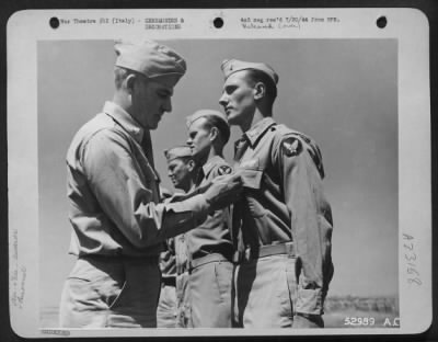 Thumbnail for Consolidated > Maj. Gen. Nathan F. Twining, Commanding General of 15th Air Force (left), pins the Distinguished Flying Cross on 1st Lt. William J. Fitzgerald, 253 East 62nd St., New York, N.Y., for "Extraordinary achievement in aerial flight as pilot" of a