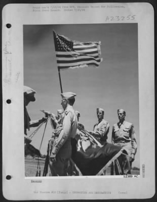 Thumbnail for Consolidated > Maj. Gen. John K. Cannon, Commanding General of the 1st Tactical Air Force (left) ties a Presidential Citation Ribbon on the Guidon of the 324th Fighter Group as Col. Leonard C. Lydon, Commanding Officer of the Group holds the standard. The highest